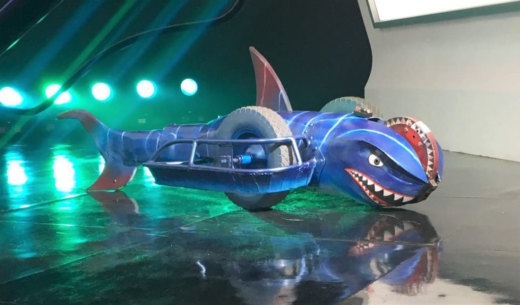 glamor shot of battlebot Sharkoprion with a reflective flooring and green-lighting in the background