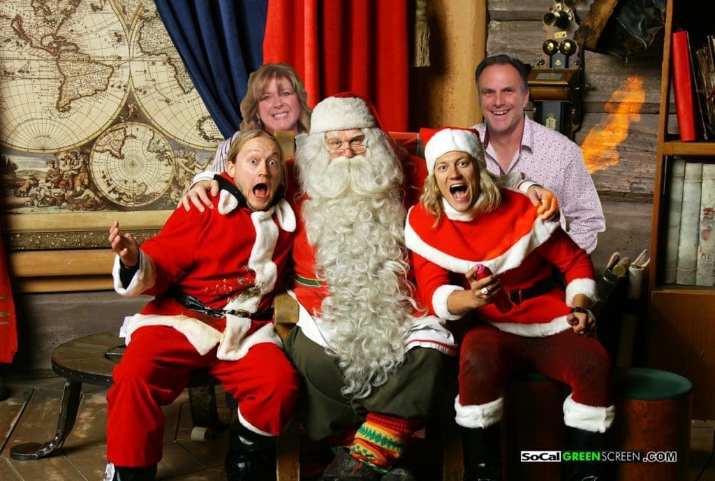 NOVO team members dressed as santa and taking a picture with the real Santa Clause who flew down from the North Pole to attend the annual NOVO holiday party.