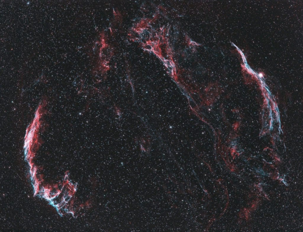 Veil nebula in a beautiful color pallet of red, blue, and white.